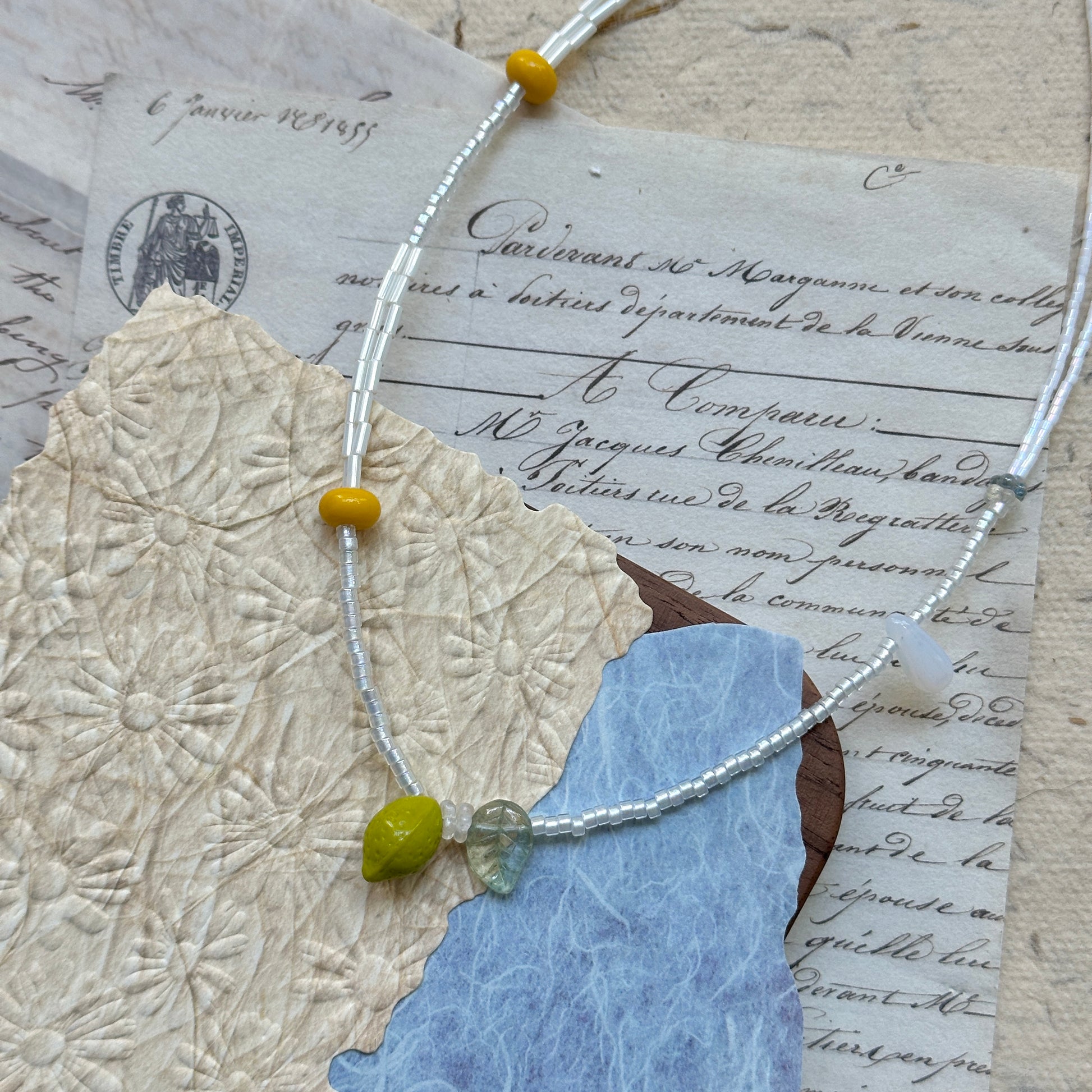 Handmade necklace with lemon glass charm and mint-leaf accent on icy-clear beads – Glazenya