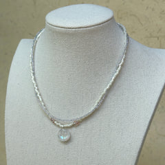 Opal Dream Necklace worn on bust, showing elegant double-strand design with shimmering opal pendant centerpiece