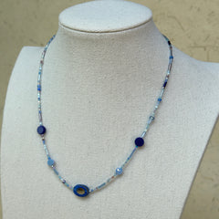 Celestial Wave Necklace worn on bust, showcasing delicate blue seed beads and celestial-inspired focal pendant