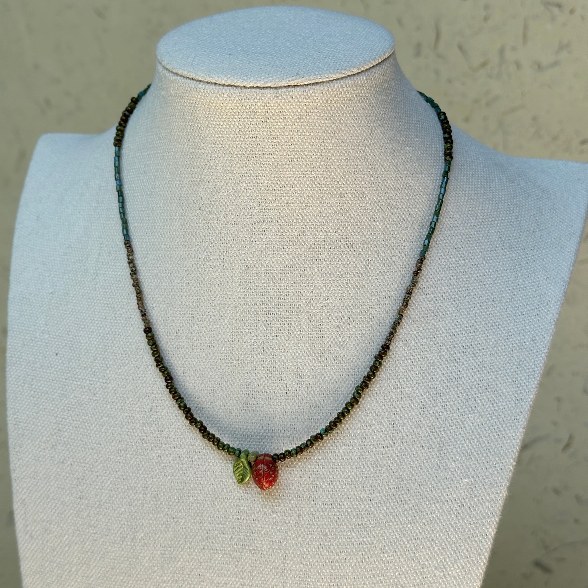 Model wearing Wild Strawberry Charm Necklace, playful summer look