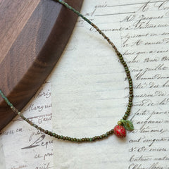 Handmade necklace with strawberry glass charm and green bead strand with leaf accent – Glazenya