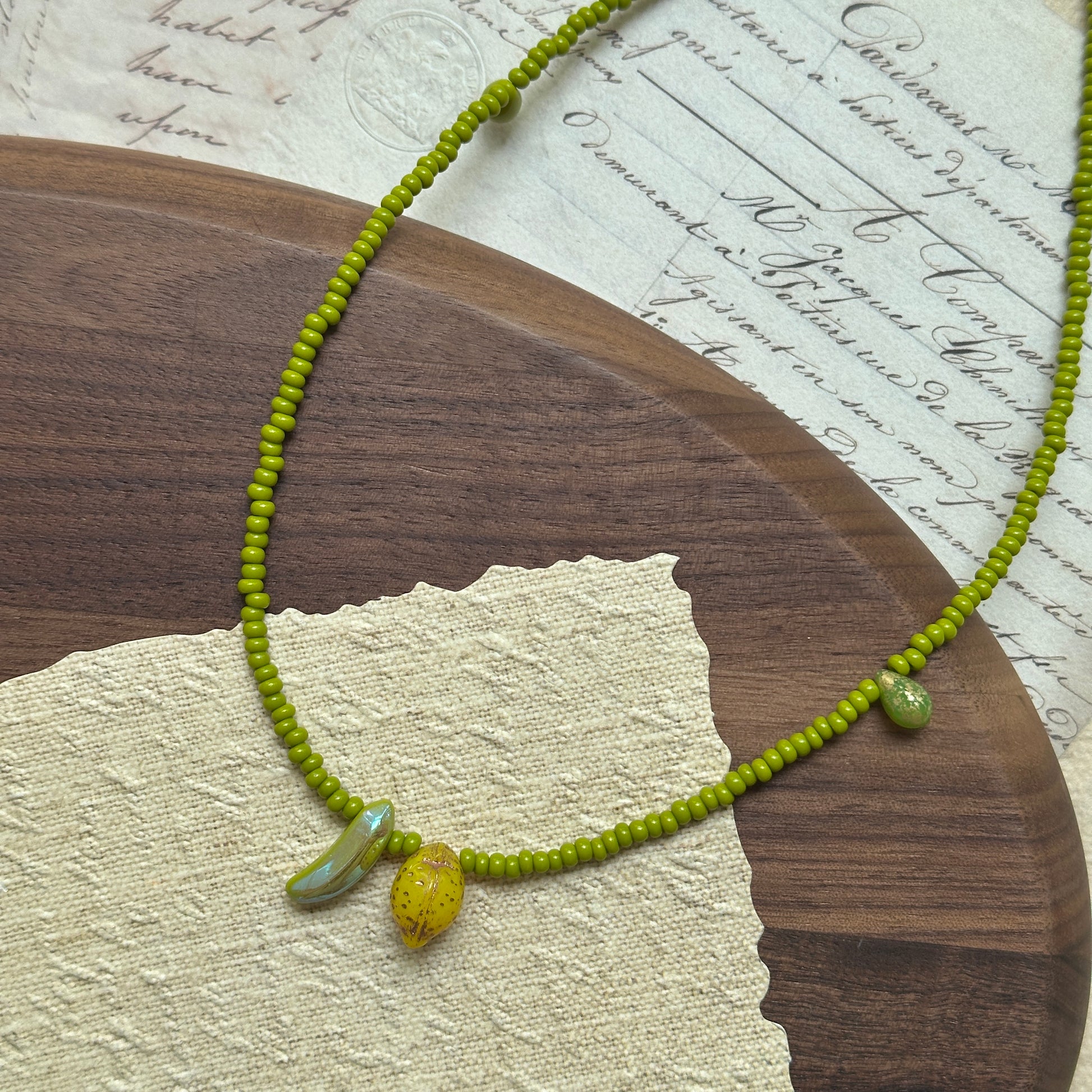 Fruit-inspired necklace with lemon and banana glass charms in lime-green beads – Glazenya