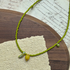 Fruit-inspired necklace with lemon and banana glass charms in lime-green beads – Glazenya