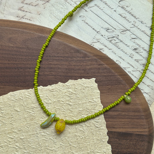 Fruit-inspired necklace with lemon and banana glass charms in lime-green beads – Glazenya
