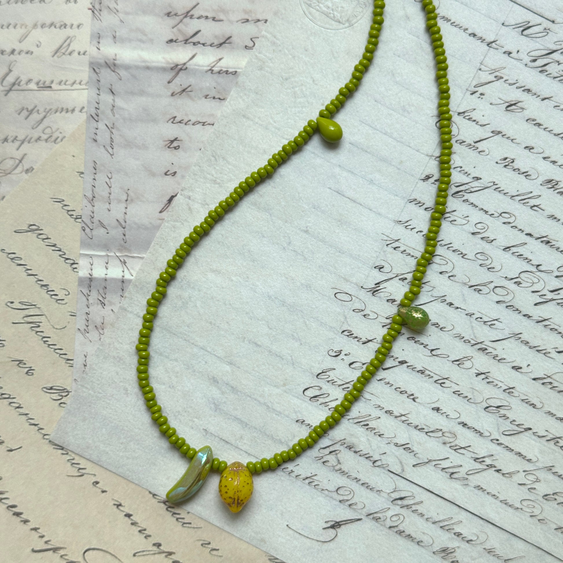 Close-up of speckled lemon bead and curved banana charm