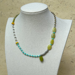 Vineyard Dream Necklace worn on white bust display, highlighting grape-cluster pendant with olive-green, turquoise, and yellow glass beads.