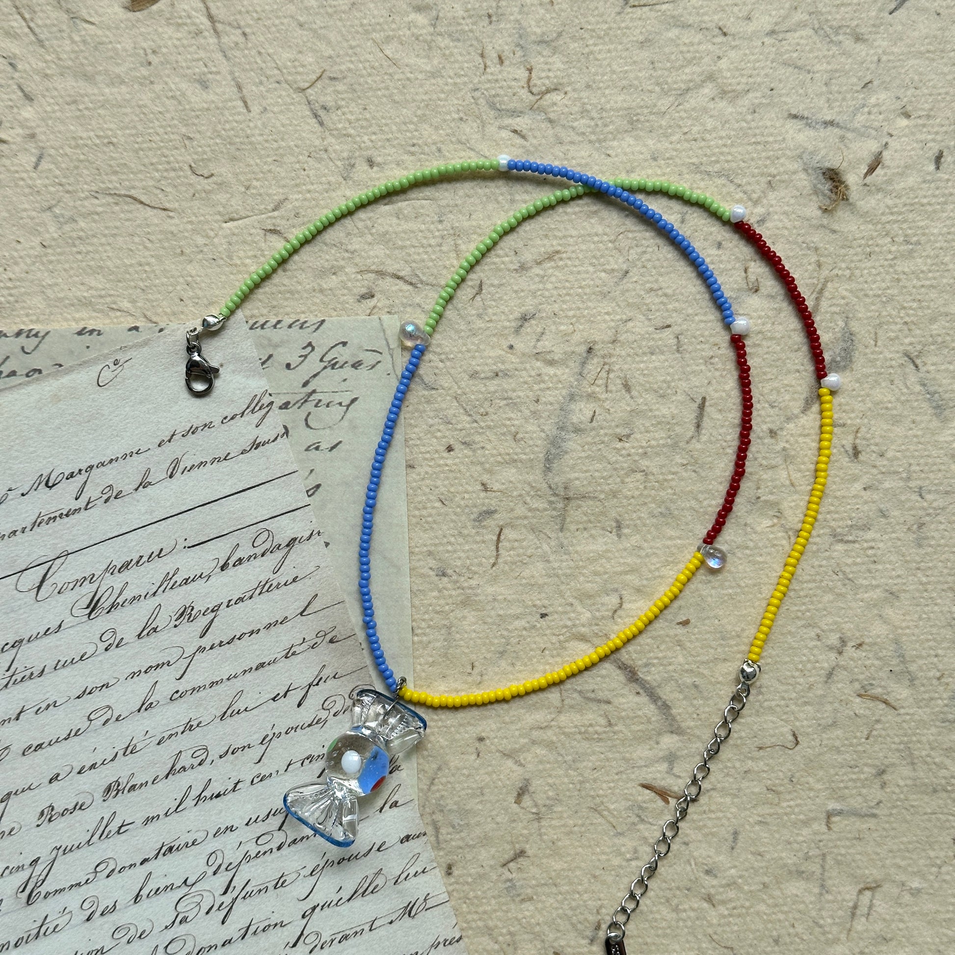 Joyful Hour Necklace featuring playful rainbow palette and crystal pendant, handcrafted with lightweight seed beads for a cheerful design.