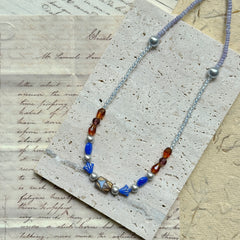 Close-up of Amber Ocean Necklace — lampwork focal bead and bead arrangement detail