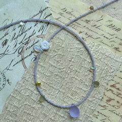 Close detail of Lilac Dew Necklace—lavender seed beads with a frosted lilac glass teardrop pendant; delicate and lightweight.