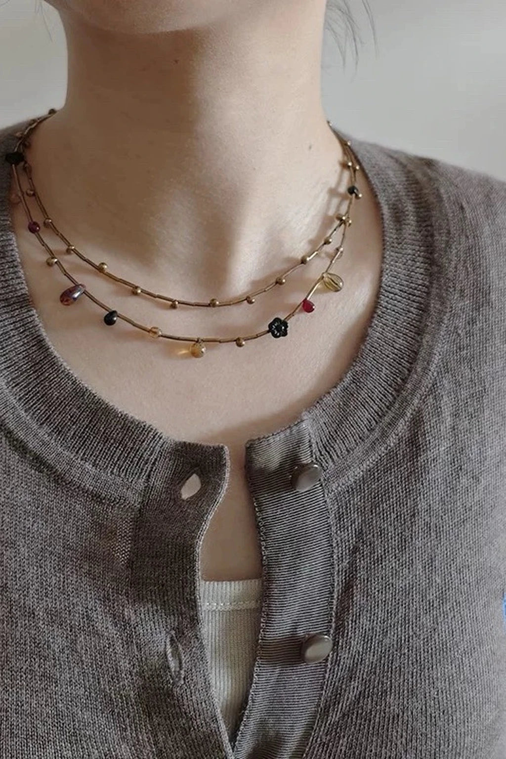 Glazenya pendant necklace on model at golden hour — delicate rose-tone stone, minimalist chain, lifestyle close-up.