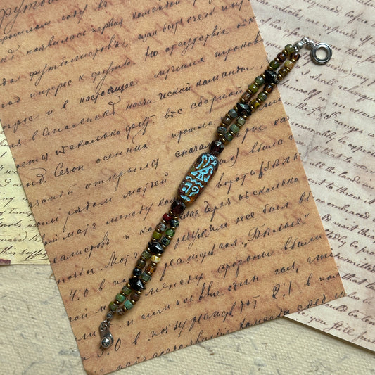 Handmade bracelet with Egyptian glyph centerpiece in bronze–turquoise tones – Glazenya