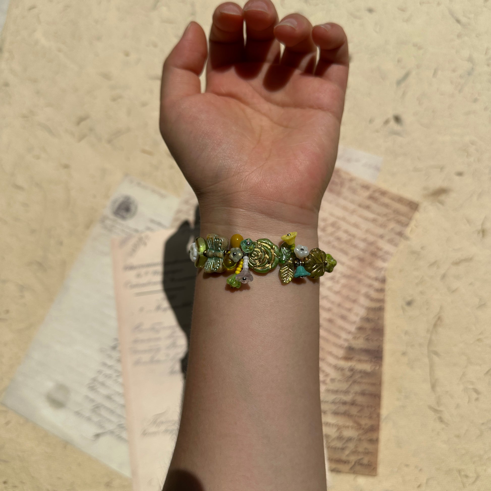 Handcrafted bracelet featuring woodland leaves and blossoms
