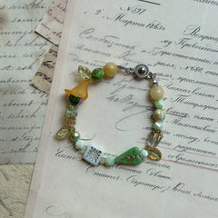 Spring Meadow Bell Bracelet with yellow bell flower and green leaves