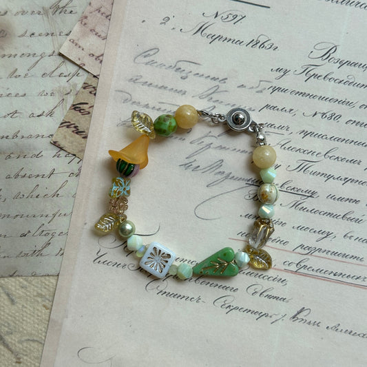 Spring Meadow Bell Bracelet with yellow bell flower and green leaves