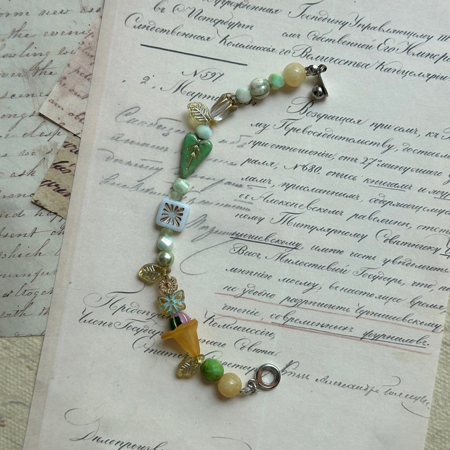 Handcrafted bracelet featuring floral charms and ivory beads