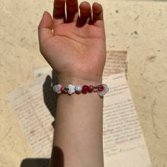 Nature-inspired bracelet with red, green, and lilac glass accents