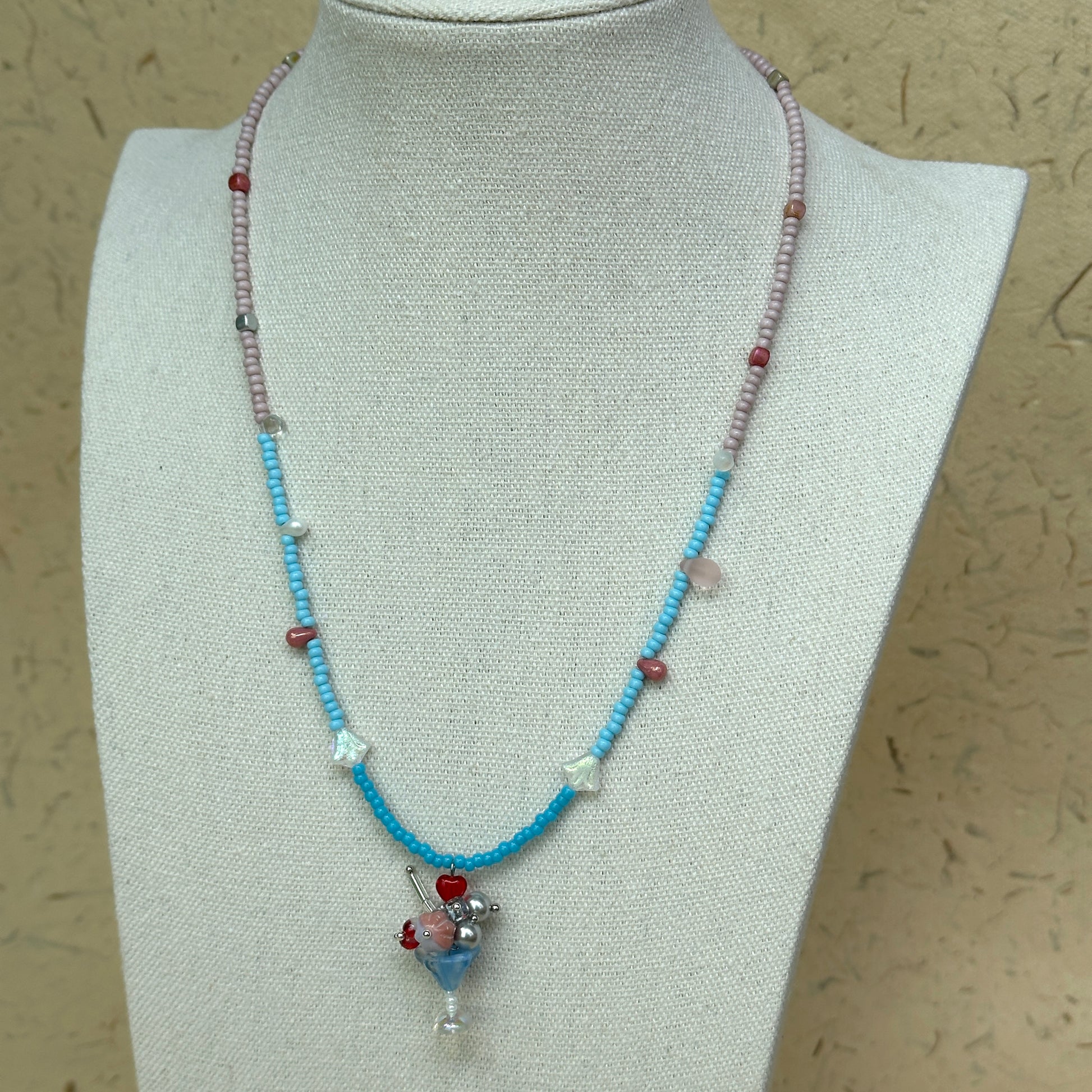 Necklace on mannequin bust, lightweight two-tone seed beads with charming flower cluster pendant