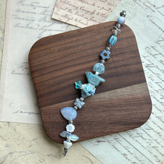 Handcrafted bracelet featuring bluebird charm and star accents