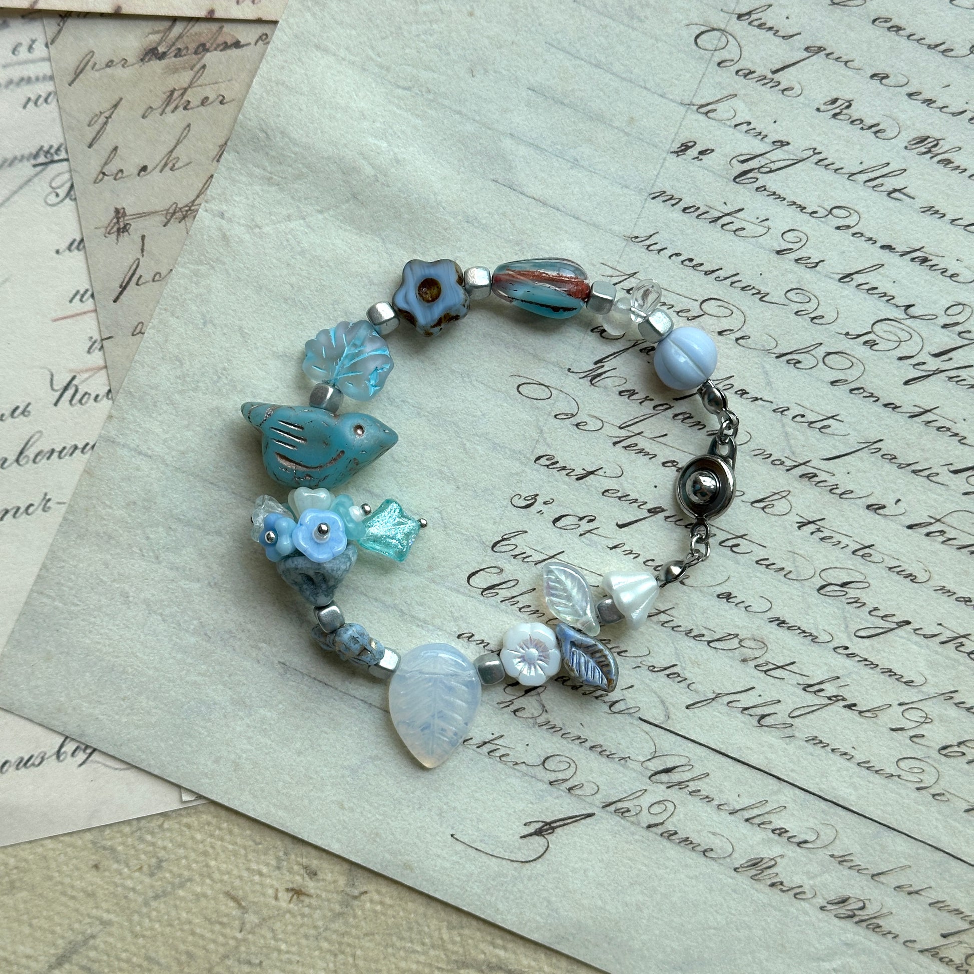 Bluebird Morning Song Bracelet with bird, floral, and leaf beads