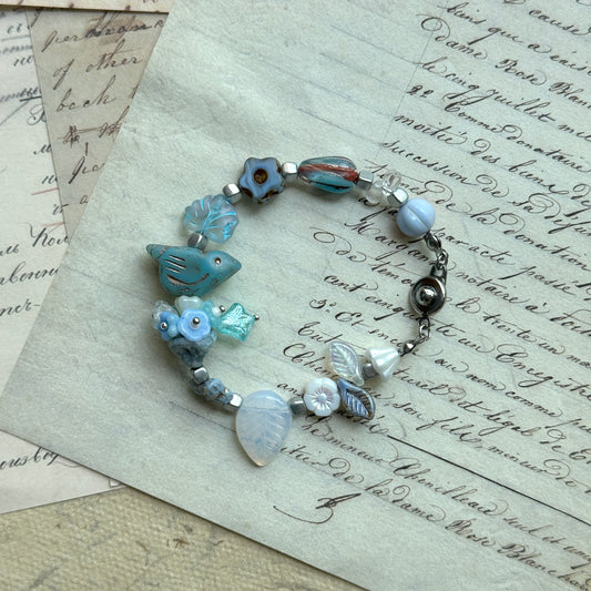 Bluebird Morning Song Bracelet with bird, floral, and leaf beads