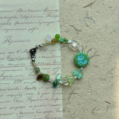 Secret Forest Blossom Bracelet with floral focal bead and green leaves