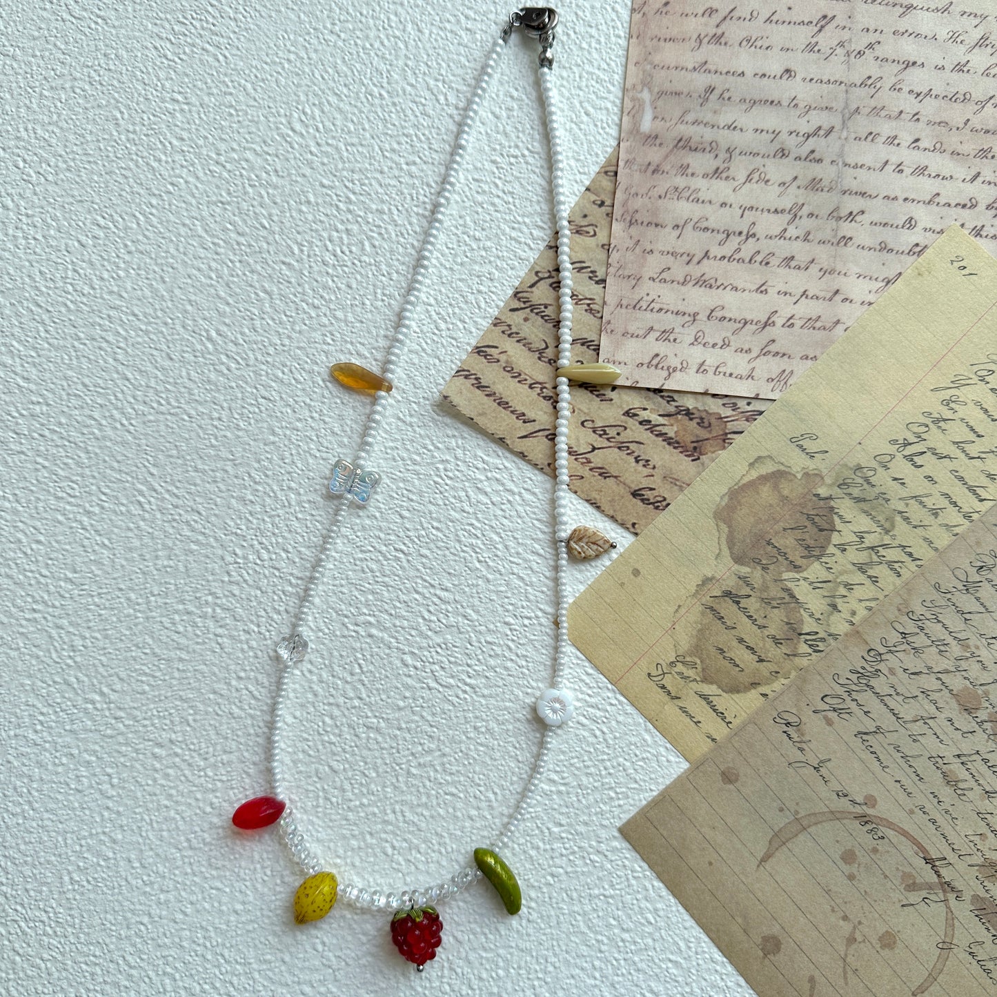 Yellow citrus-inspired bead detail with handcrafted seed bead strand