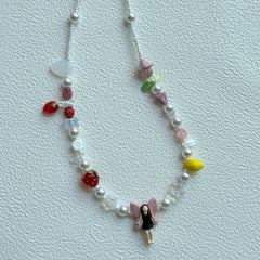 Fairy Garden Necklace with fairy pendant and fruit charms on display bust