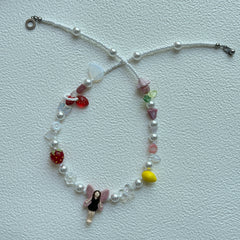 Close-up of pink-wing fairy pendant centerpiece on necklace
