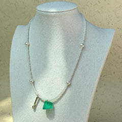 White pearls strung with seed beads in handcrafted necklace