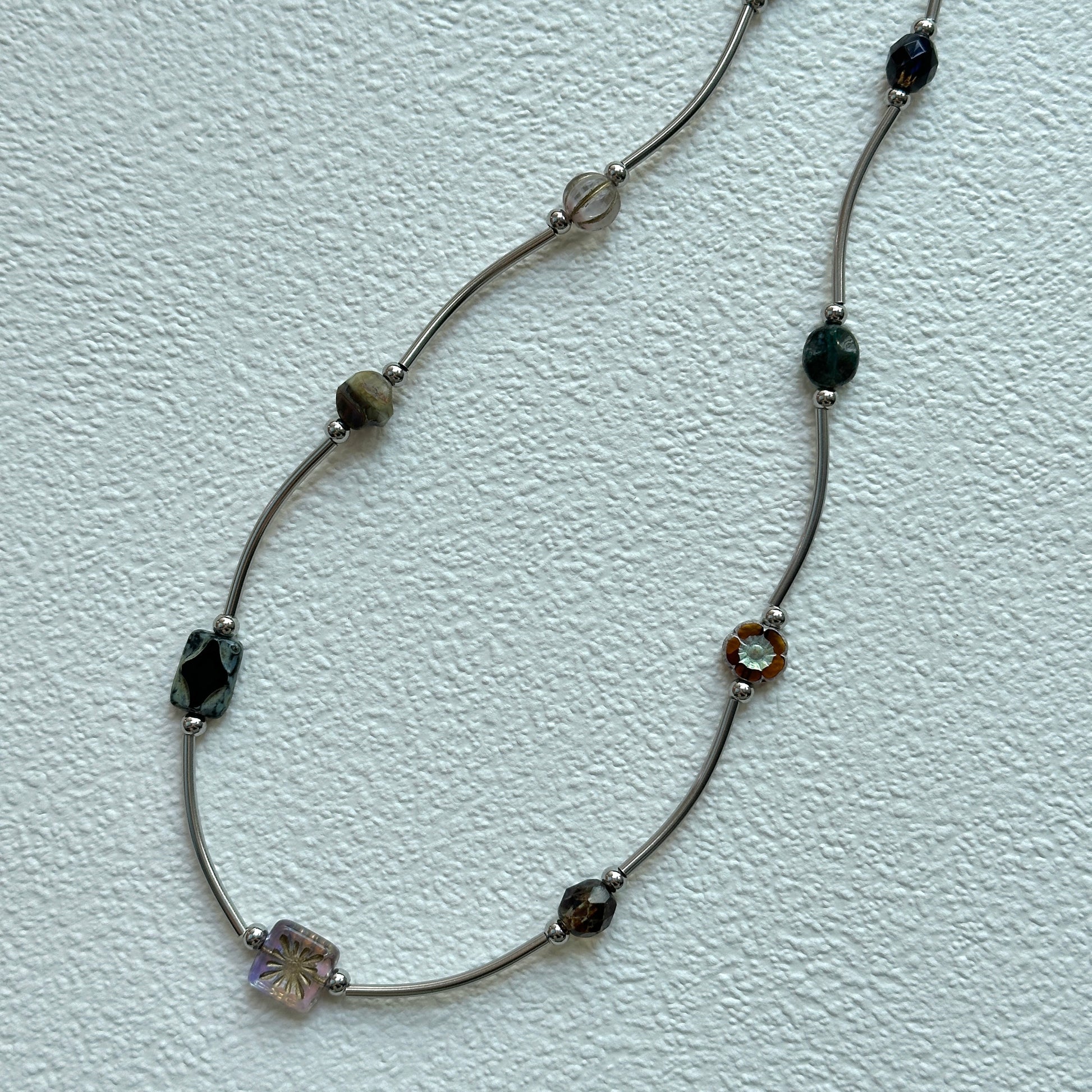 Vintage Path Necklace with mixed earthy beads and curved metal links on display