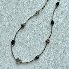 Vintage Path Necklace with mixed earthy beads and curved metal links on display