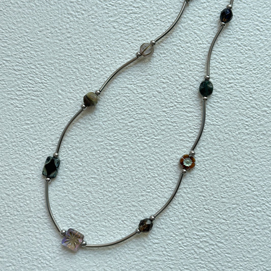 Vintage Path Necklace with mixed earthy beads and curved metal links on display