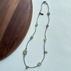 Close-up of turquoise bead with engraved sunburst design