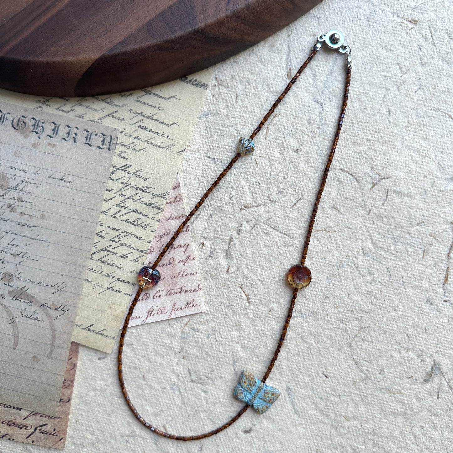 Floral accent bead detail on Rustic Butterfly Necklace