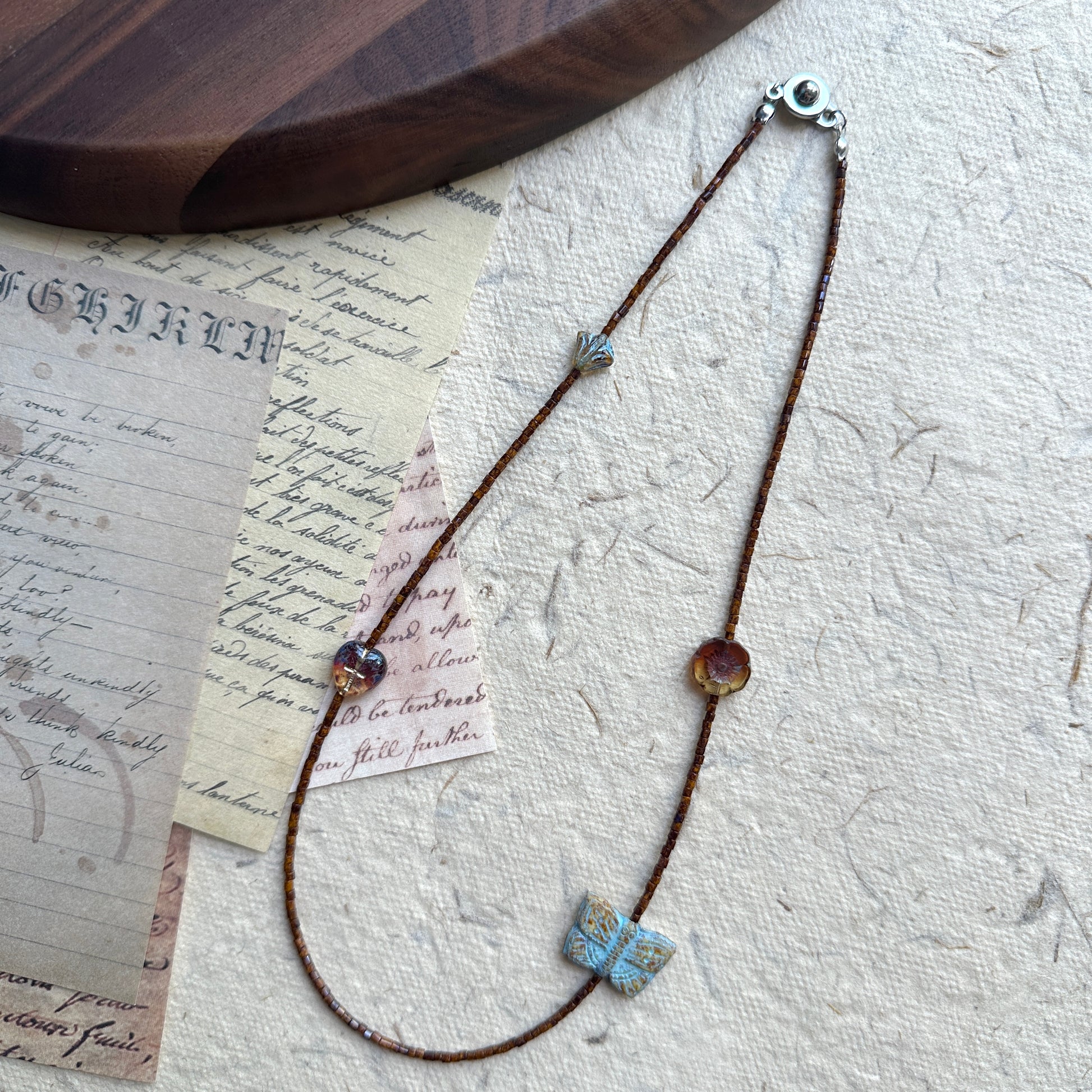 Floral accent bead detail on Rustic Butterfly Necklace