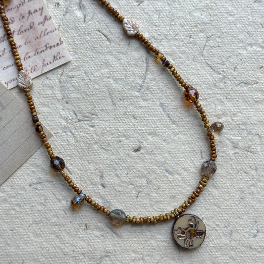 Cancer Relic Necklace with crab motif pendant on display bust