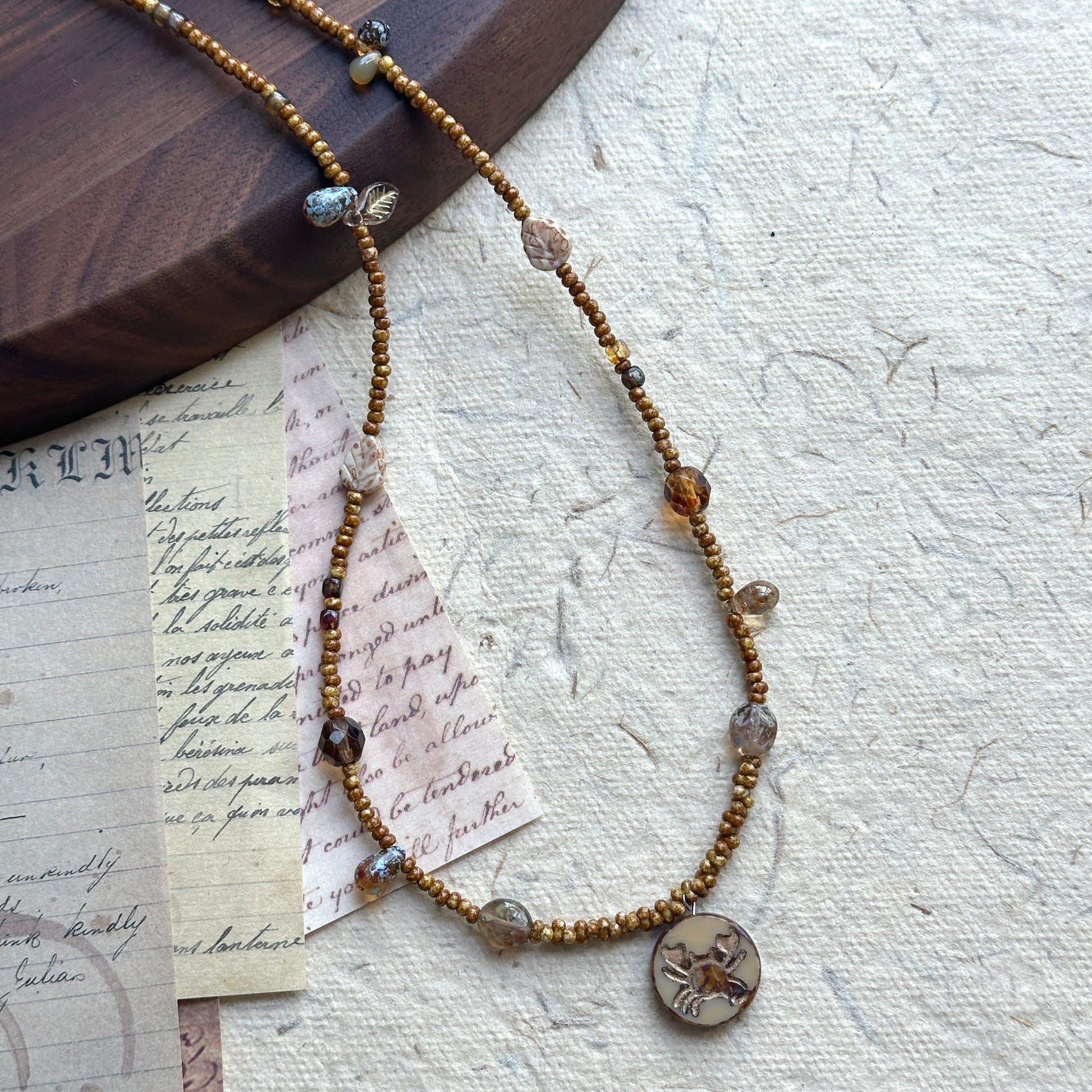 Smoky glass accent bead detail on Cancer Relic Necklace