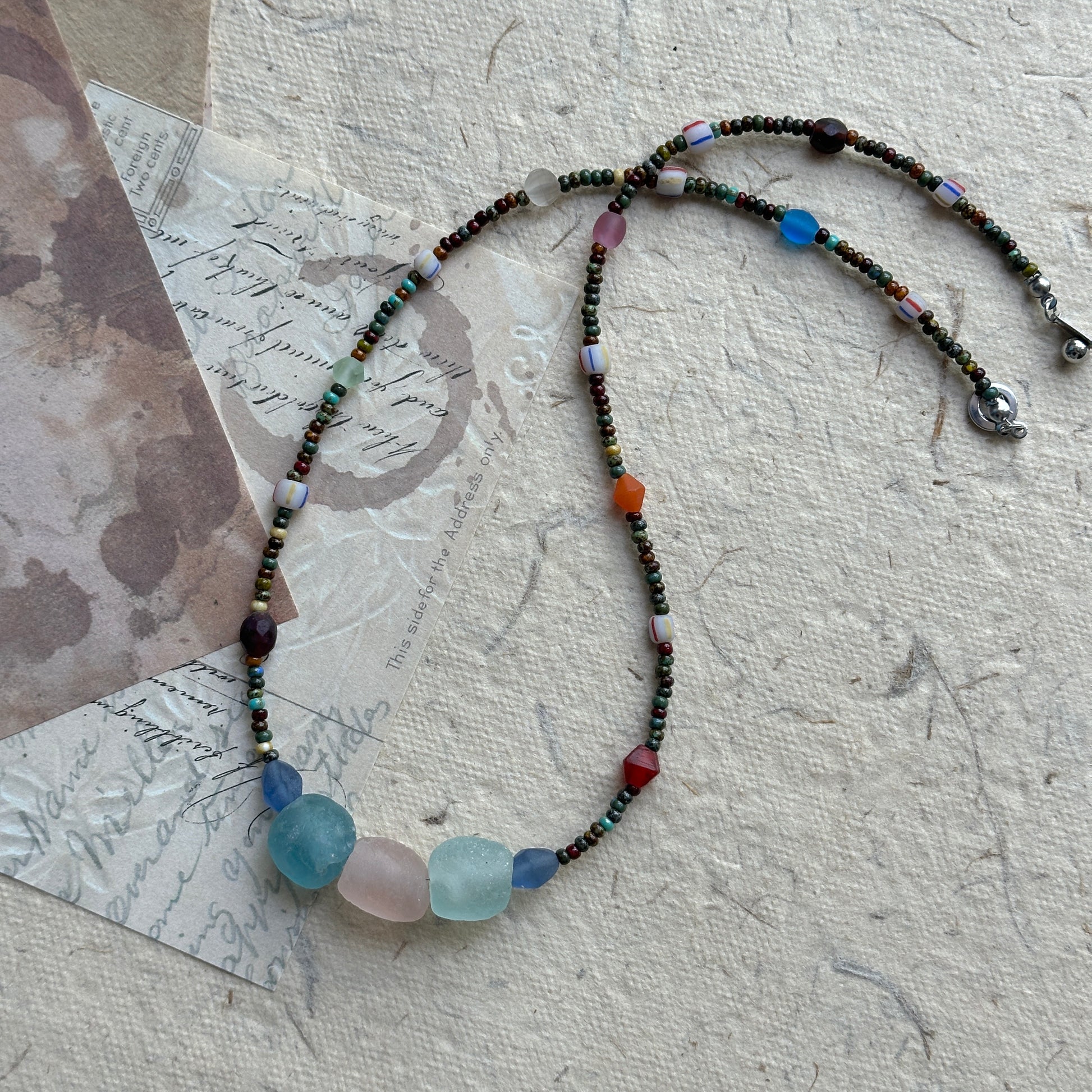 Wanderlust Stone Necklace with multicolor beads on textured background