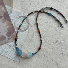 Wanderlust Stone Necklace with multicolor beads on textured background