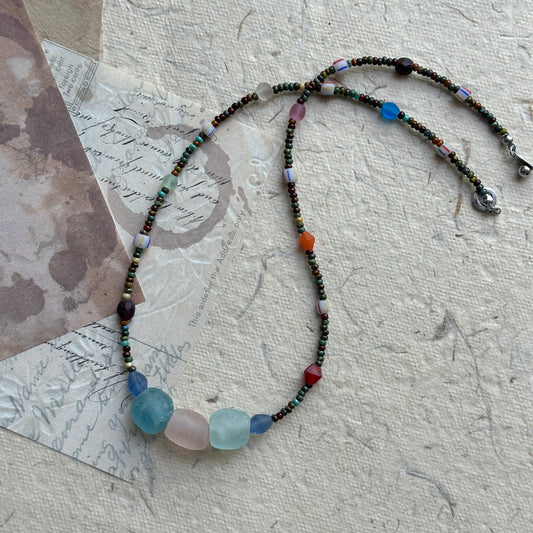 Wanderlust Stone Necklace with multicolor beads on textured background