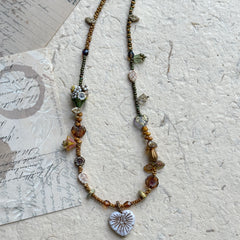Floral and leaf-shaped bead accents in woodland tones