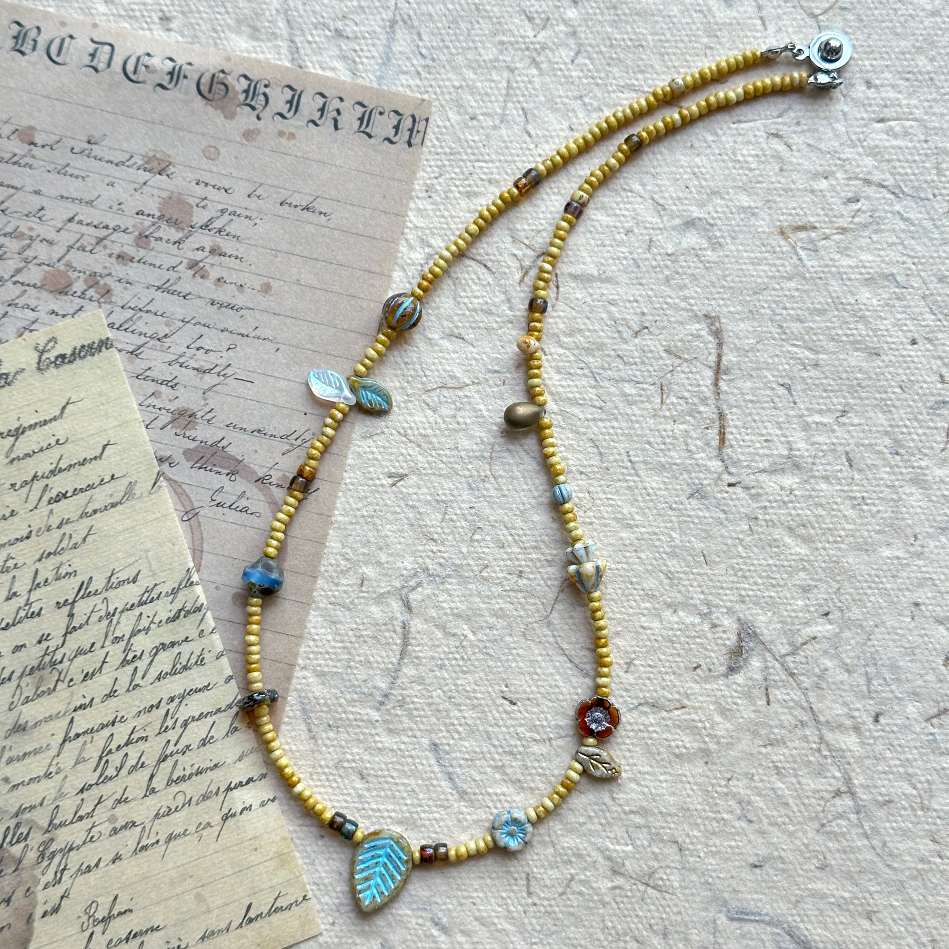 Floral and leaf-shaped bead details in Meadow Leaf Necklace