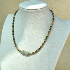 Rustic handcrafted necklace with brown, amber, and green beads