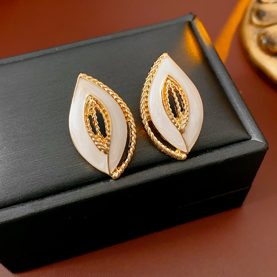 Leaf-shaped stud earrings with gold outline and white enamel – Golden Leaf Elegance Stud Earrings.