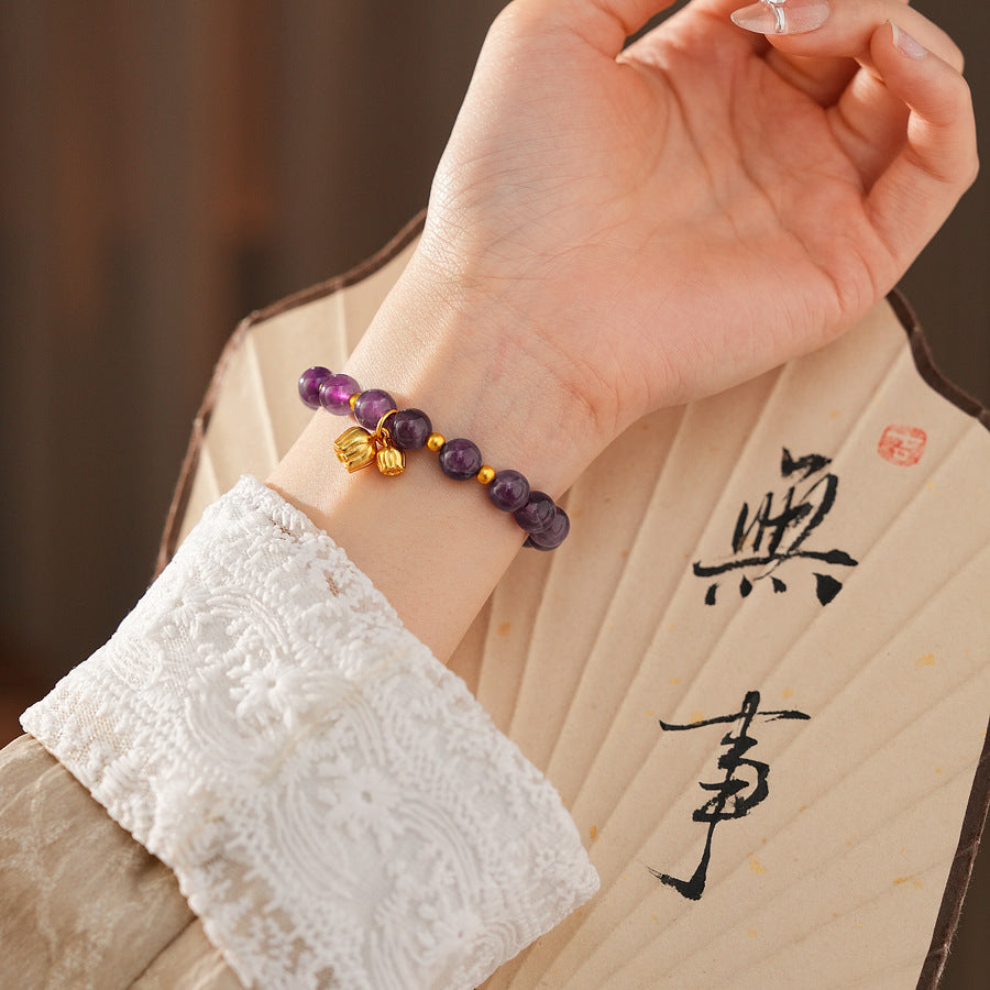 Natural amethyst beaded bangle with gold-tone accents and a lucky charm (Floral or Gourd) — Violet Fortune Amethyst Bangle.