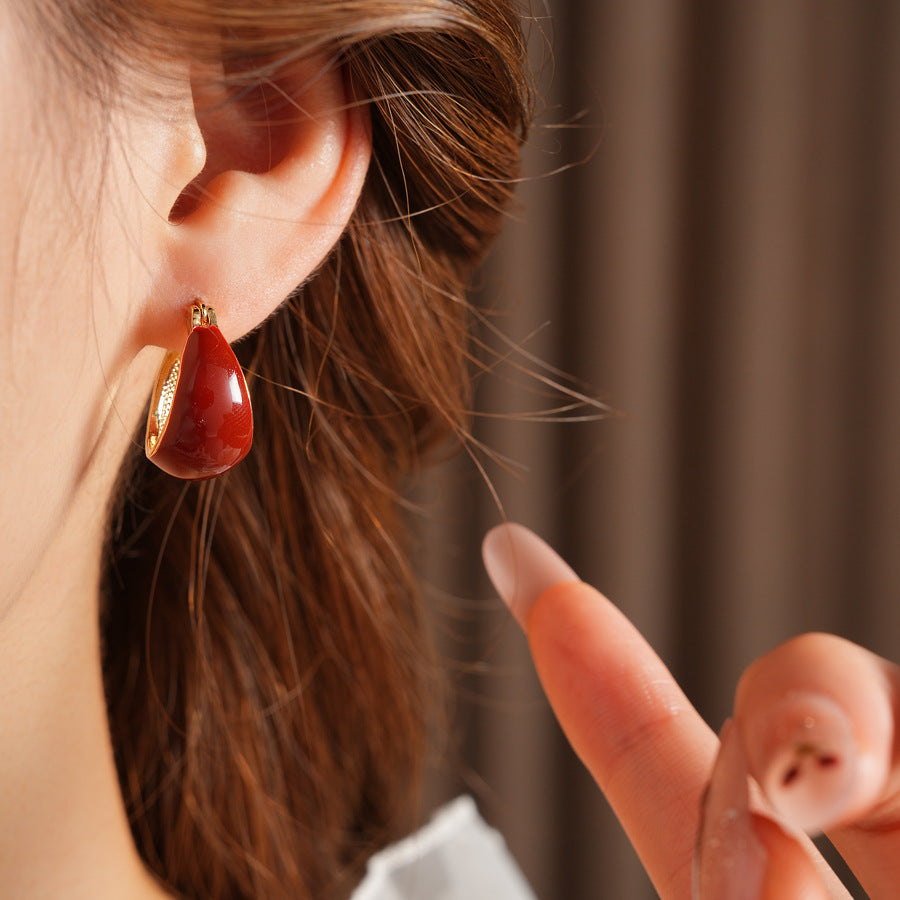 Cherry-red enamel dome huggie hoop earrings with gold tone finish — Cherry Lacquer Dome Huggies.