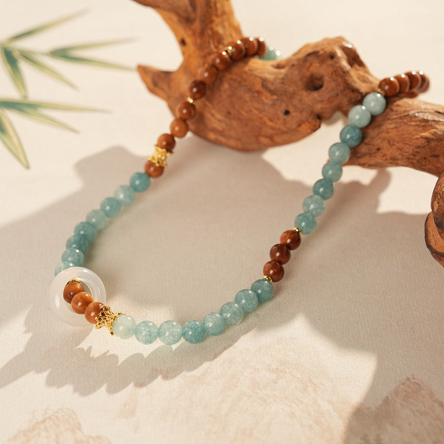 A double-wrap bracelet of sea blue and brown chalcedony beads, embellished with white rings - Dual-Tone Chalcedony Double-Wrap Bracelet.