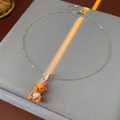Silver-tone necklace with coffee teddy pendant and pink hat, matching teddy stud earrings with heart crystal — Sweetheart Teddy Crystal Jewelry.
