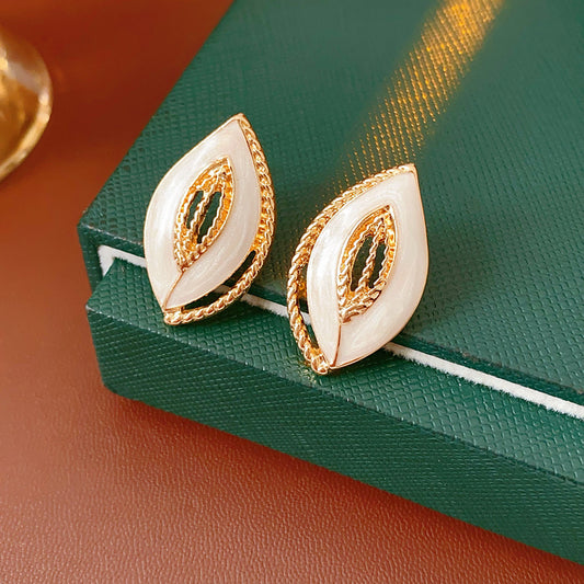 Leaf-shaped stud earrings with gold outline and white enamel – Golden Leaf Elegance Stud Earrings.