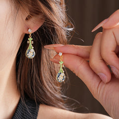 Gold-tone filigree drop earrings with green and blue enamel lute motifs, accented by zircons and tiny pearls — Verdant Lute Filigree Drops.